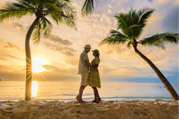 bang tao beach phuket thailand, couple of men and women watching sunset on the beach